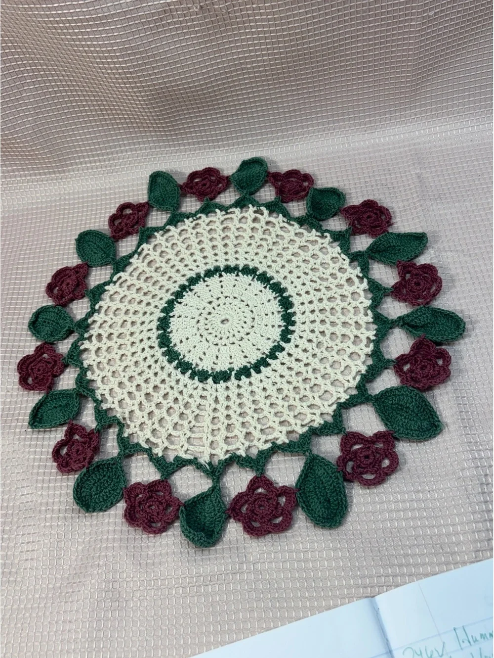 vintage crocheted doily centerpiece featuring a cream, maroon rose & dark green